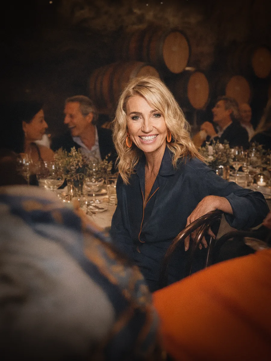 Suzanne sharing wine at an outdoor table with guests